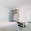 Camera minimalista con letto e armadio.
