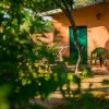 Bungalow arancione con sedie verdi.
