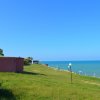 Vista mare con prato e spiaggia.