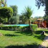 Area verde con piscina e scivolo.